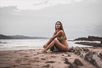 Portrait of a brunette woman wearing a swimsuit on the beach in summer