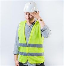 Worried young engineer holding forehead isolated. Frustrated young engineer holding forehead and looking down. Worried male engineer man holding forehead