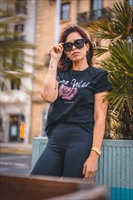 Lifestyle in the city. A young brunette with sunglasses