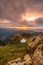 Wild camping on the top of a mountain at sunset