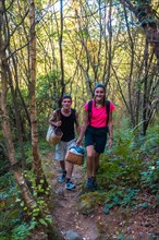 A young Caucasian couple walking in the mountains for a lovely summer picnic