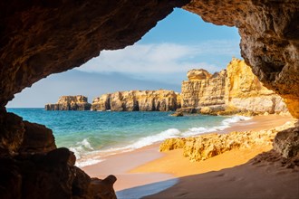 A natural summer beach cave at Praia da Coelha