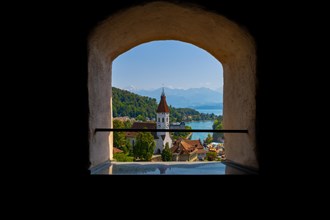 Window View over City of Thun and Lake Thun with Mountain and a Church in a Sunny Day in Thun