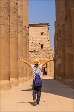 A young tourist wearing a hat visiting the Egyptian Temple of Luxor. Egypt