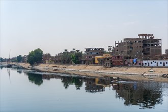 Traditional Egyptian villages on the bank of the river Nile. Views sailing on the cruise on the river Nile from Luxor to Aswer