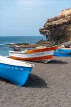 Fishing boats on the beach of the coastal town of Ajuy near the town of Pajara