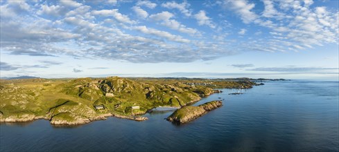Aerial panorama of the coastline of the Ross of Mull peninsula and the fishing village of Fionnphort on the right