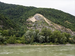 View over the Danube to a rocky slope and wooded area