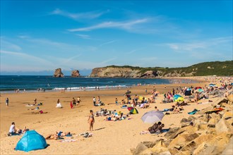 Hendaye beach one summer afternoon full of people enjoying the water in summer