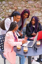 Young businesswomen of black ethnicity. In a teamwork meeting