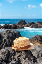 Hat next to a natural pool in summer
