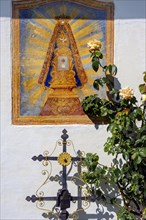 Christian fresco and iron burial cross with rose bush in the Swabian Open Air Museum