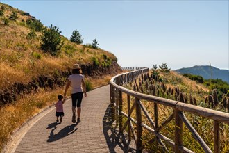 A mother walking with her son at the viewpoint of Miradouro do paredao