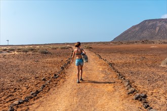 A young tourist girl walking the trails of Isla de Lobos