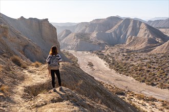 A young hiker girl up in the canyon on Rambla de Lanujar in the Tabernas desert