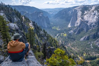 A young winged seated Taft point looking at Yosemite National Park and El Capitan. United States