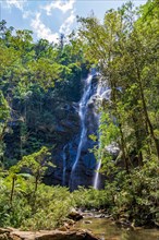 Waterfall between rocks and trees in the rainforest in the state of Minas Gerais