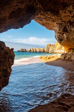 A cave entering the water from the beach at Praia da Coelha