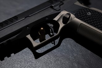 Modern Elegant Handgun and Bullet on Grey Background in Switzerland