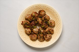 Top view of plate with minced meat meatballs with green pea and cranberry jam