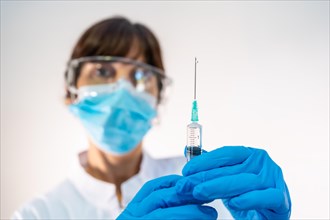 Female doctor preparing the injection of the coronavirus vaccine. Antibodies