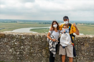 A young family visiting the famous Mont Saint-Michel Abbey from inside