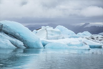 Beautiful icebergs on Jokulsarlon Ice Lake in the golden circle of southern Iceland on a cold August morning