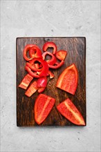 Top view of fresh bell pepper on wooden cutting board