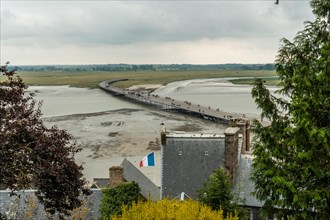 The arrival trail to the famous Mont Saint-Michel Abbey at high tide in the Manche department