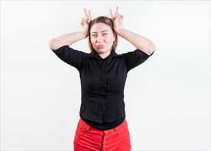 People making horns gesture with their fingers