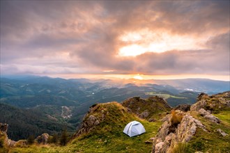 Wild camping on the top of a mountain at sunset