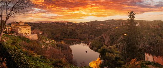 Panoramic at sunset on the Tagus river of the medieval city of Toledo in Castilla La Mancha