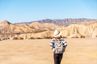 A young woman walking in the Las Salinas ravine on a trek in the Tabernas desert