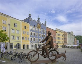 Monument cyclist with dog at the historic town square of
