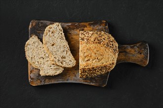 Top view of artisan bread with sunflower seeds on wooden cutting board