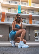 Portrait of a girl in a skirt enjoying the city in summer
