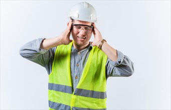 Male engineer with headache on isolated background. Young engineer with migraine holding his head isolated