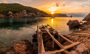 Wooden piers on the beach at sunset in Benirras in Ibiza. vacation concept
