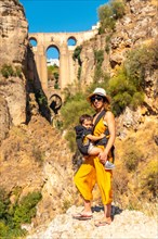 A young woman with her son at the new bridge viewpoint in Ronda