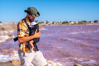 Young father visiting the pink lagoon of Torrevieja