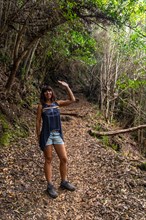 A young woman on the trekking trail of the Los Tinos natural park on the northeast coast on the island of La Palma