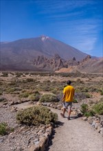 A young tourist on the volcano trekking trail at the Llano de Ucanca viewpoint in the Teide Natural Park in Tenerife
