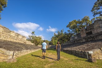 A couple strolling through the ball game in the temples of Copan Ruinas. Honduras