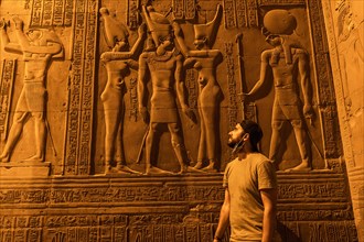 A young man visiting the beautiful temple of Kom Ombo at night