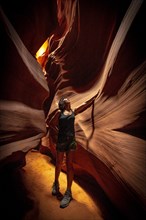 A young woman admiring the beauty of the Upper Antelope Canyon in the town of Page