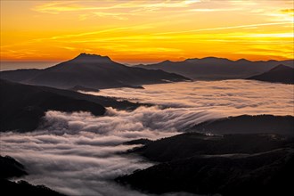 Detail of the beautiful Mount Larrun on a winter morning by the sea of clouds at the golden hour of dawn. Basque Country