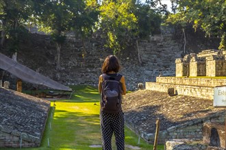 A young girl watching The ball game field in the temples of Copan Ruinas. Honduras