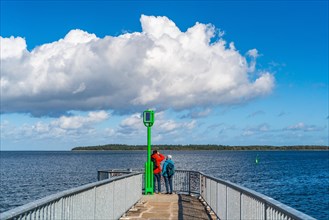 People on the pier at the Utkiek lookout in the fishing village of Wieck with a view over the Greifswald Bodden