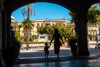 A mother with her son in some arches in Jerez de la Frontera in Cadiz