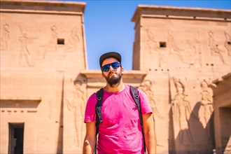 A young man in a pink shirt at the Temple of Philae